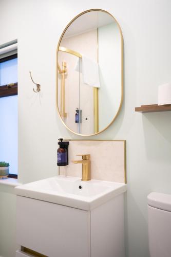 a bathroom with a sink and a mirror at Friels Terrace in Swatragh