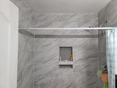 a bathroom with a shower with a sink at Denver Layover B&B in DEN