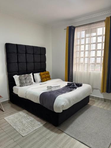 Ένα ή περισσότερα κρεβάτια σε δωμάτιο στο Lake View Loft Nakuru