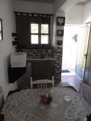 a kitchen with a table and a sink and a window at Anna Studios in Myrties