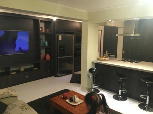 a living room with a tv and a table at casa celeste in Puerto Montt