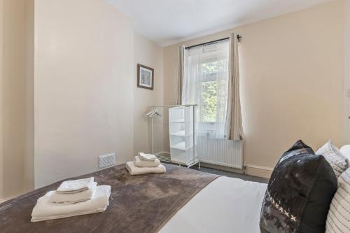 a bedroom with a bed with towels on it at 3 Bed House in Leicester, by ARP Homes, Close to M1 & M69, Free Parking, Perfect for Contractors and Long Stays in Leicester