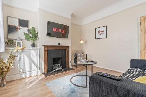 a living room with a couch and a fireplace at 3 Bed House in Leicester, by ARP Homes, Close to M1 & M69, Free Parking, Perfect for Contractors and Long Stays in Leicester