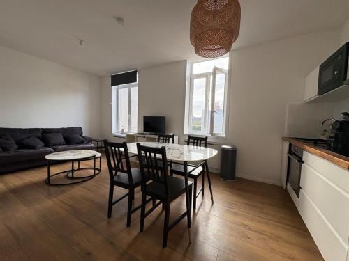 a kitchen and a living room with a table and chairs at Digue & Dream - 4-person apartment in Dunkerque