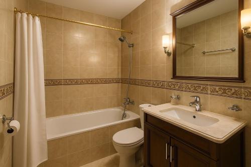 a bathroom with a sink and a toilet and a bath tub at Hotel Estrella del Norte in Larache
