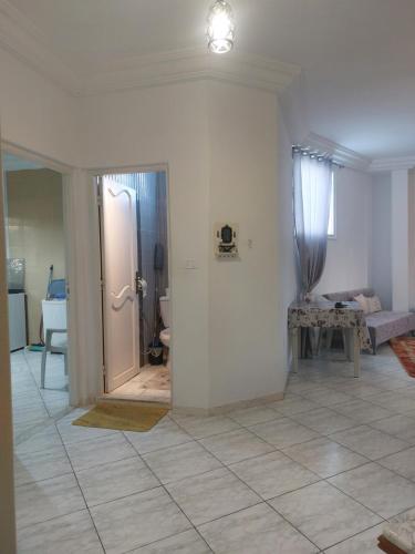 uma sala de estar com uma porta que dá para um cômodo com em Location saisonnière entre mer, forêt et calme em Raʼs al Jabal