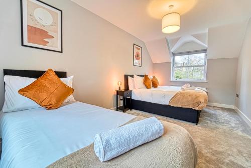 a bedroom with two beds and a window at Central and Stylish, Garden and Parking in Coventry