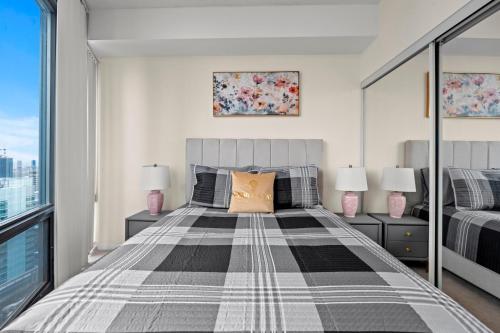 a bedroom with a large bed with two lamps at High Floor 1 Bedroom Condo City View Downtown Toronto in Toronto