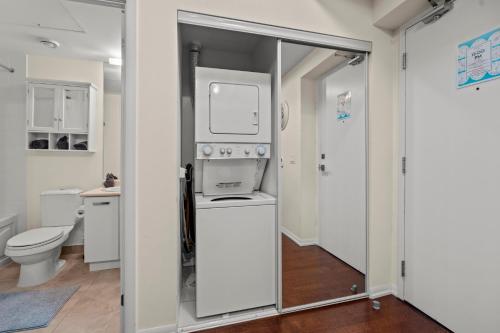 a bathroom with a sink and a washer and dryer at High Floor 1 Bedroom Condo City View Downtown Toronto in Toronto