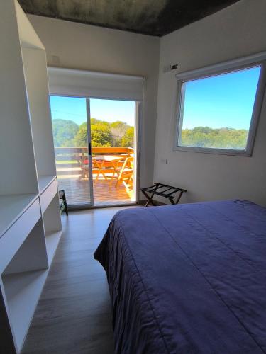 a bedroom with a bed and a view of a deck at Tiké in Ostende