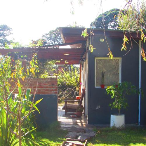 a small blue house with a bench in front of it at La Maruja de Acantilados in Mar del Plata