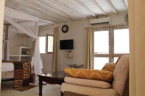 un soggiorno con divano e tavolo di The Villa Luxury Suites Hotel a Diani Beach