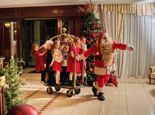 a santa claus is pulling a group of children at Hotel President Solin in Solin