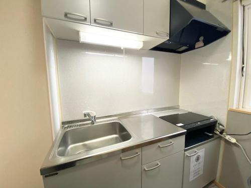 Una cocina o cocineta en 優ハウス夢ハウス2階