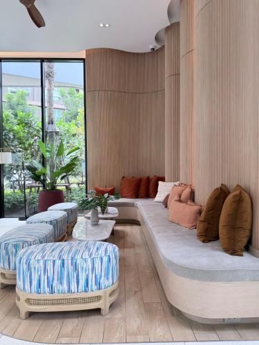 a living room with two large couches with pillows at DCondo Kathu ใกล้หาดป่าตอง in Kathu