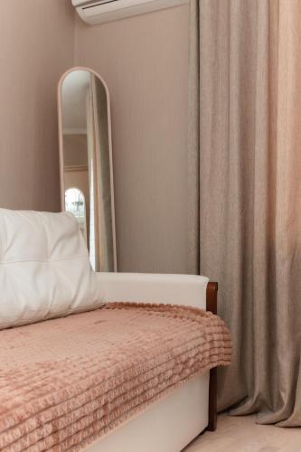 a bedroom with a bed and a mirror at Standard 1-bd Apartment LAVINA in Sumy