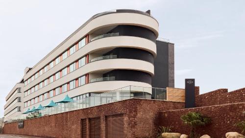 a tall building with a glass facade at Hotel Indigo Torquay, By IHG in Torquay