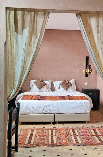 a bedroom with a large bed in a room at Riad Dar Haven in Tamraght Ou Fella