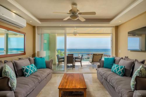 un soggiorno con un divano e un tavolo di Luxury Beachfront Condo Punta Mita a Punta Mita