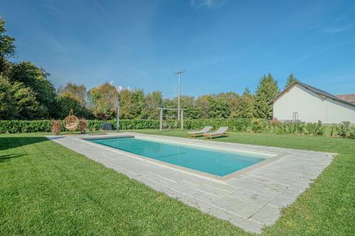 a swimming pool in the middle of a yard at Vila Trate with Shared Pool and Garden in Ljutomer