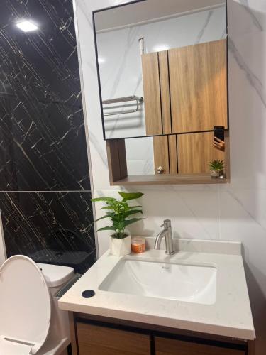 a bathroom with a sink and a toilet and a mirror at Ban slow life Koh Libong in Ko Kwang
