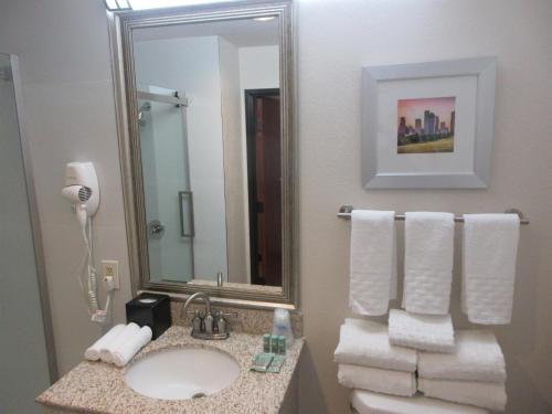 a bathroom with a sink and a mirror at Best Western Champions Forest Inn and Suites in Houston