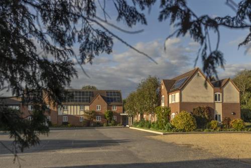 a row of houses with solar panels on their roofs at Kings Court Hotel Alcester, BW Signature Collection in Stratford-upon-Avon
