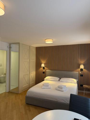 a bedroom with a bed with two towels on it at Appartamenti Anna in Sirmione