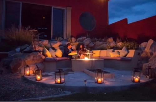 a woman sitting on a couch in a patio with candles at Casa La Vista in San Miguel de Allende