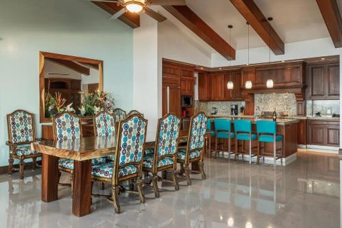 a kitchen with a wooden table and chairs at Luxury Oceanfront Penthouse Concierge Cook in Punta Mita