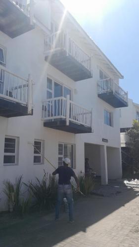 a man standing in front of a white building at Sunbird 2 in Cape St Francis