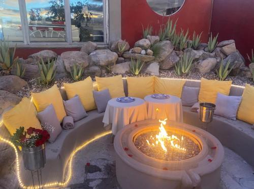 a patio with two tables and a fire pit at Casa La Vista in San Miguel de Allende