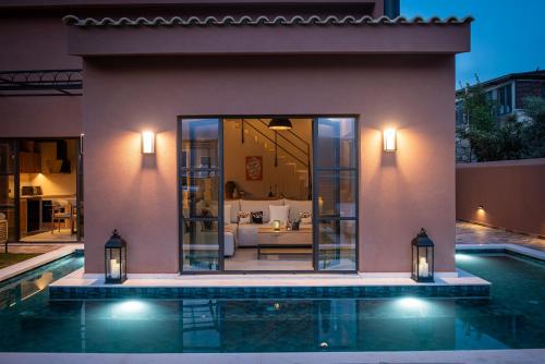 a villa with a swimming pool at night at Arcasa Villas Collection by Omilos Hotels in Archanes