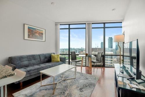 a living room with a couch and a table at 1 Bedroom Condo Burano Downtown Toronto in Toronto