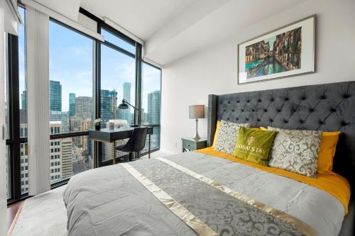 a bedroom with a large bed and a large window at 1 Bedroom Condo Burano Downtown Toronto in Toronto