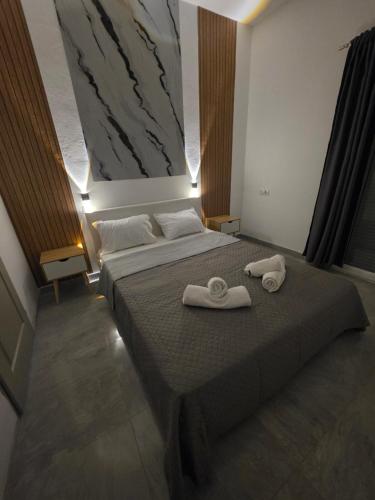 a bedroom with a bed with two towels on it at Mirtos4seasons Harmony in Myrtos