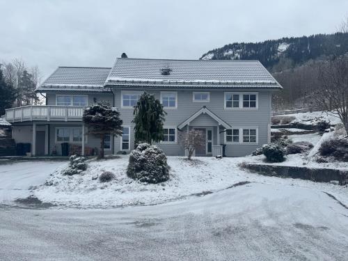 a large house with snow on the ground at 3 min til Skibakken - WiFi - Parkering - Varme in Vossevangen