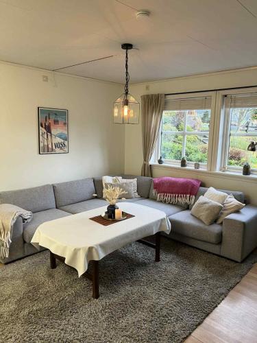 a living room with a couch and a table at Cozy Central Apartment - Free Parking & Wifi in Vossevangen