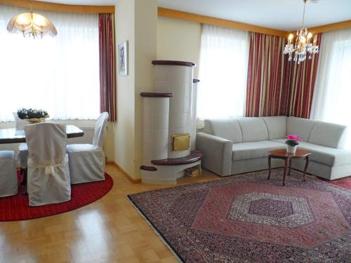 a living room with a white couch and a table at Ferienhaus Stefanie in Sankt Kanzian