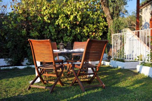 two chairs and a table in the grass at Hotel Marina in Kolios
