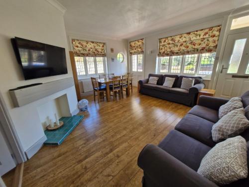 a living room with a couch and a fireplace at The Tea House - A Stones Throw from Beach in Broadstairs