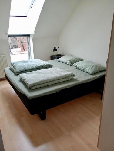 a large bed in a room with a window at Apartment in the heart of Herning in Herning
