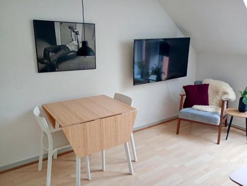 a living room with a table and a chair at Apartment in the heart of Herning in Herning