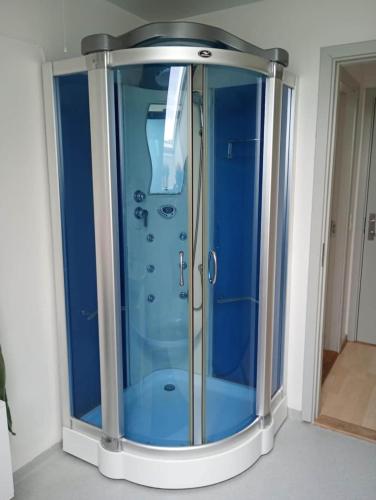 a shower with a glass door in a room at Apartment in the heart of Herning in Herning