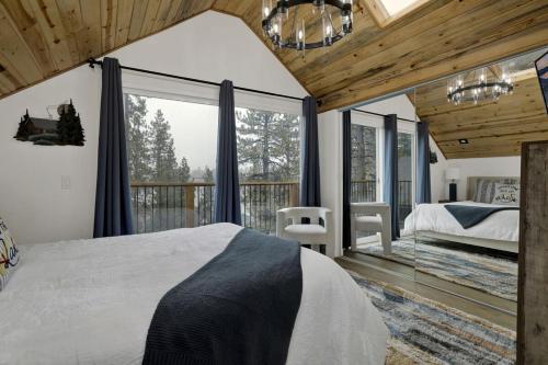 a bedroom with a bed and a balcony at Stairway to Heaven at Big Bear- Million Dollar Lake Views - Modern Luxury Chalet w/ Hot Tub in Big Bear Lake