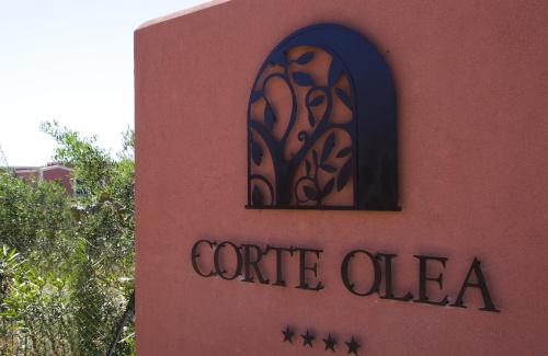 a building with a sign on the side of it at Corte Olea Resort in Paceco