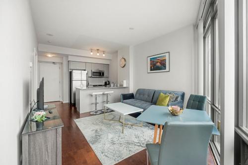 a living room with a couch and a table at 1 Bedroom Condo Burano Downtown Toronto in Toronto