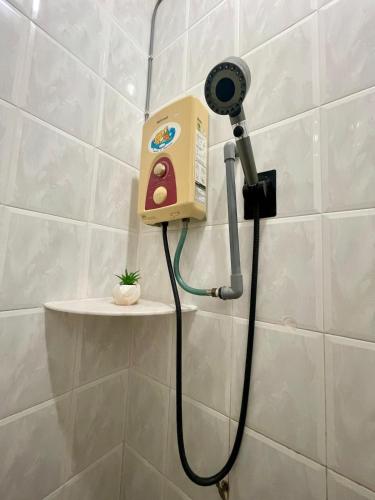 a blow dryer is attached to a wall in a bathroom at IF Homestay Mersing in Mersing