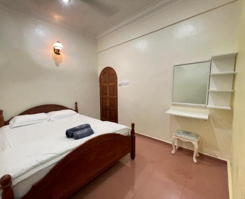 a bedroom with a bed and a flat screen tv at IF Homestay Mersing in Mersing