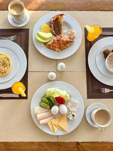 a table with three plates of food on it at Daniela Diving Resort Dahab in Dahab